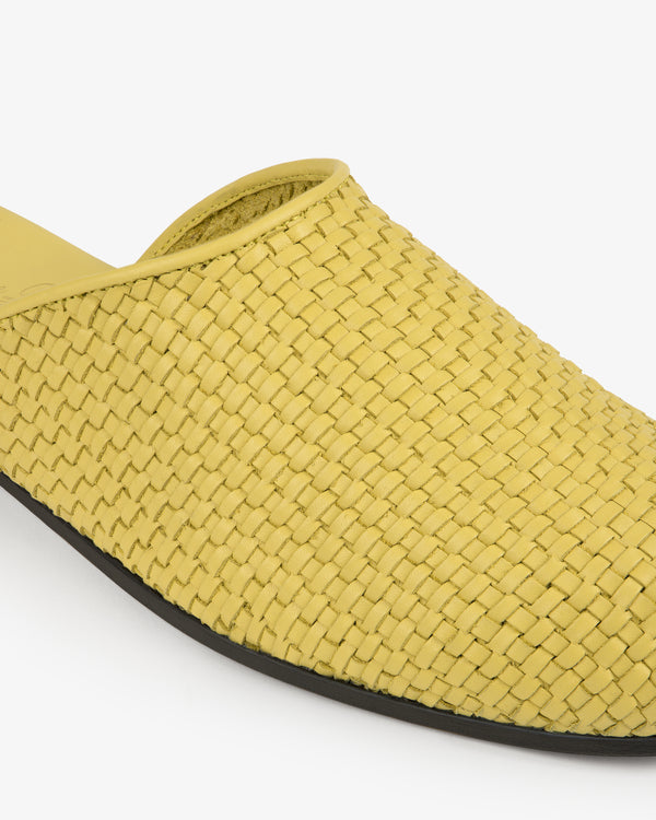 Leather Raffia Mule in yellow with a black sole, side view shown against a white background.