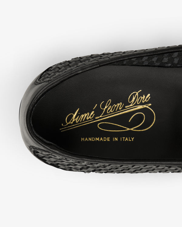 Top view of a Leather Raffia Loafer in black with Aimé Leon Dore and Handmade in Italy in gold on the insole.