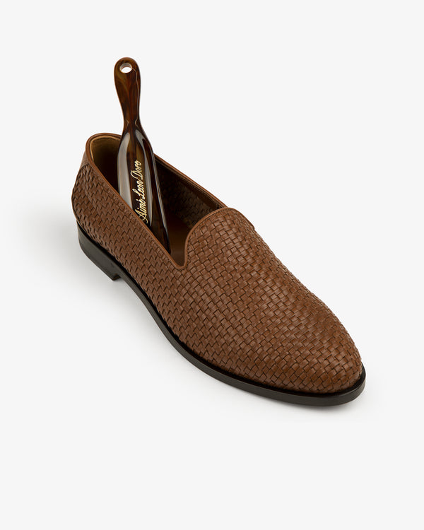 Leather Raffia Loafer with a black shoehorn inside, displayed on a white background.