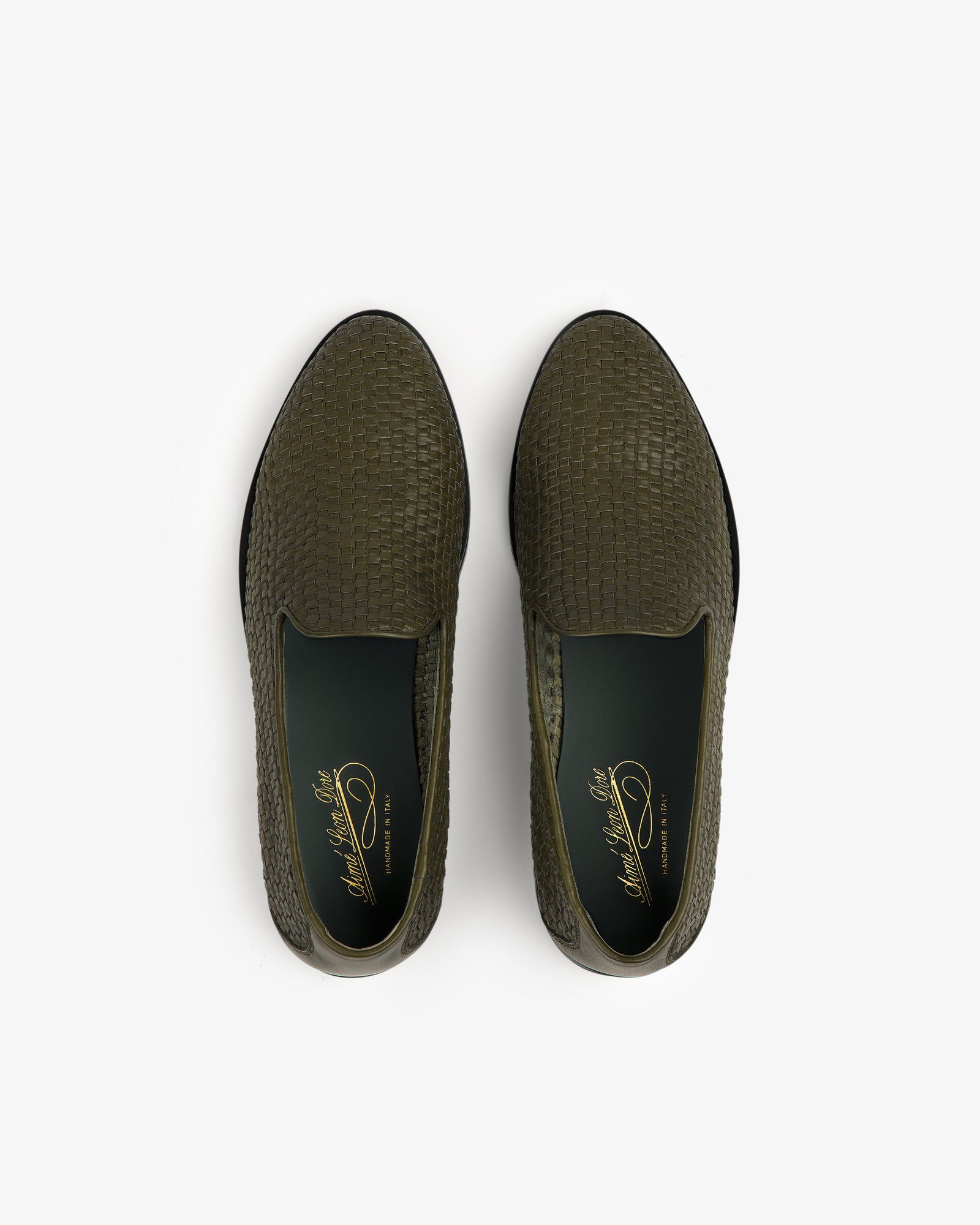 Top view of a pair of Leather Raffia Loafers in olive green with woven texture and dark green insoles.