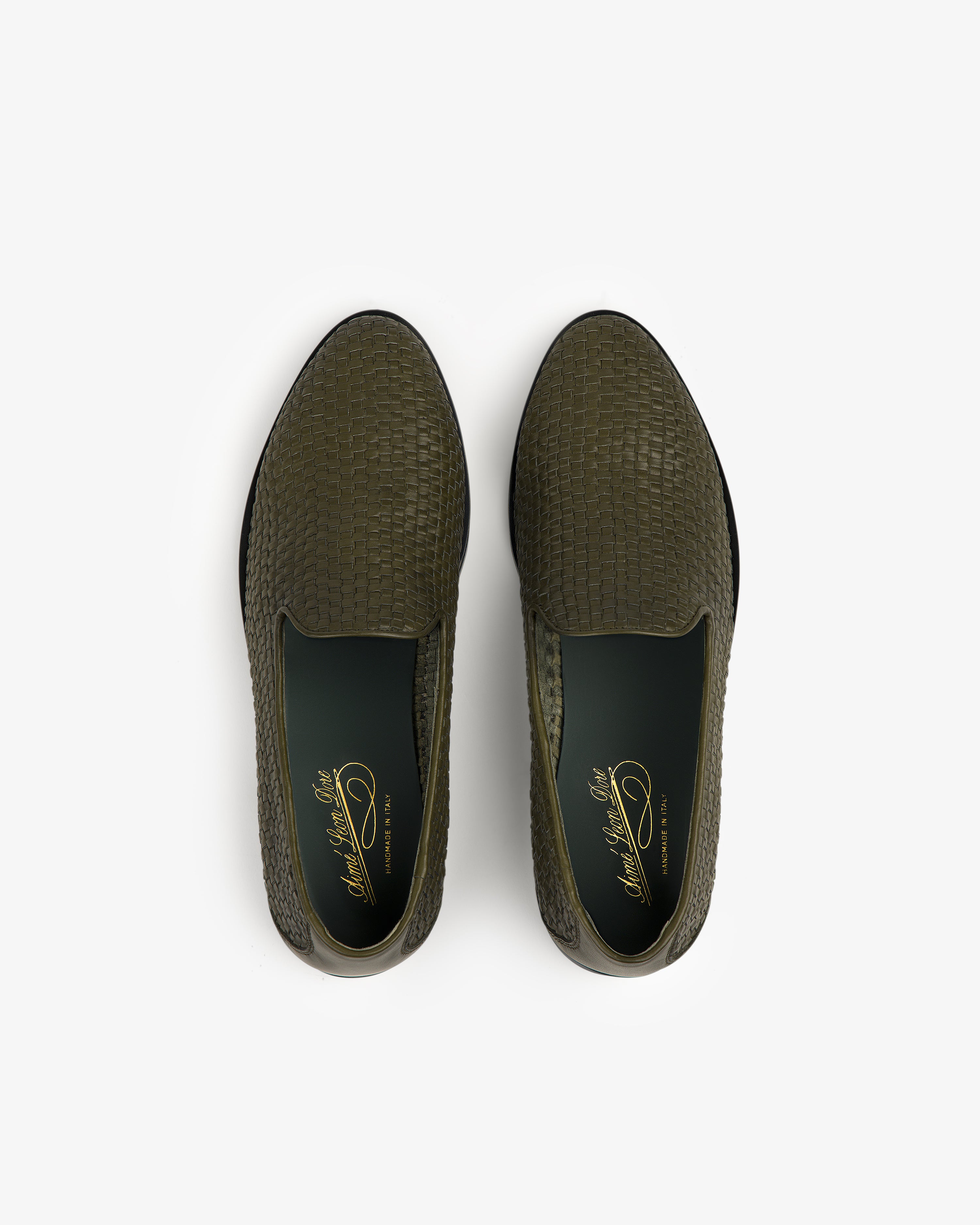 Top view of a pair of Leather Raffia Loafers in olive green with woven texture and dark green insoles.