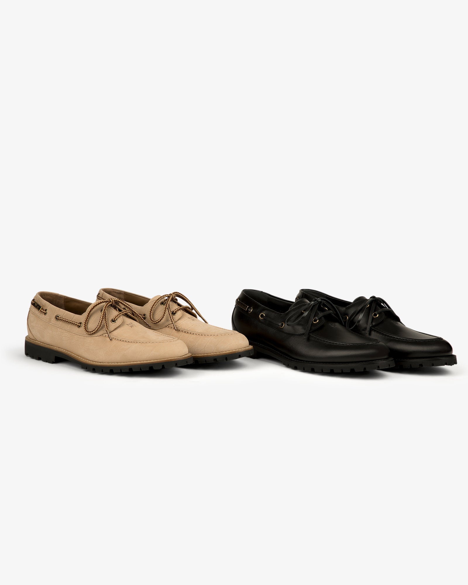 Beige and black Pápia Boat Shoes side by side on a white background.