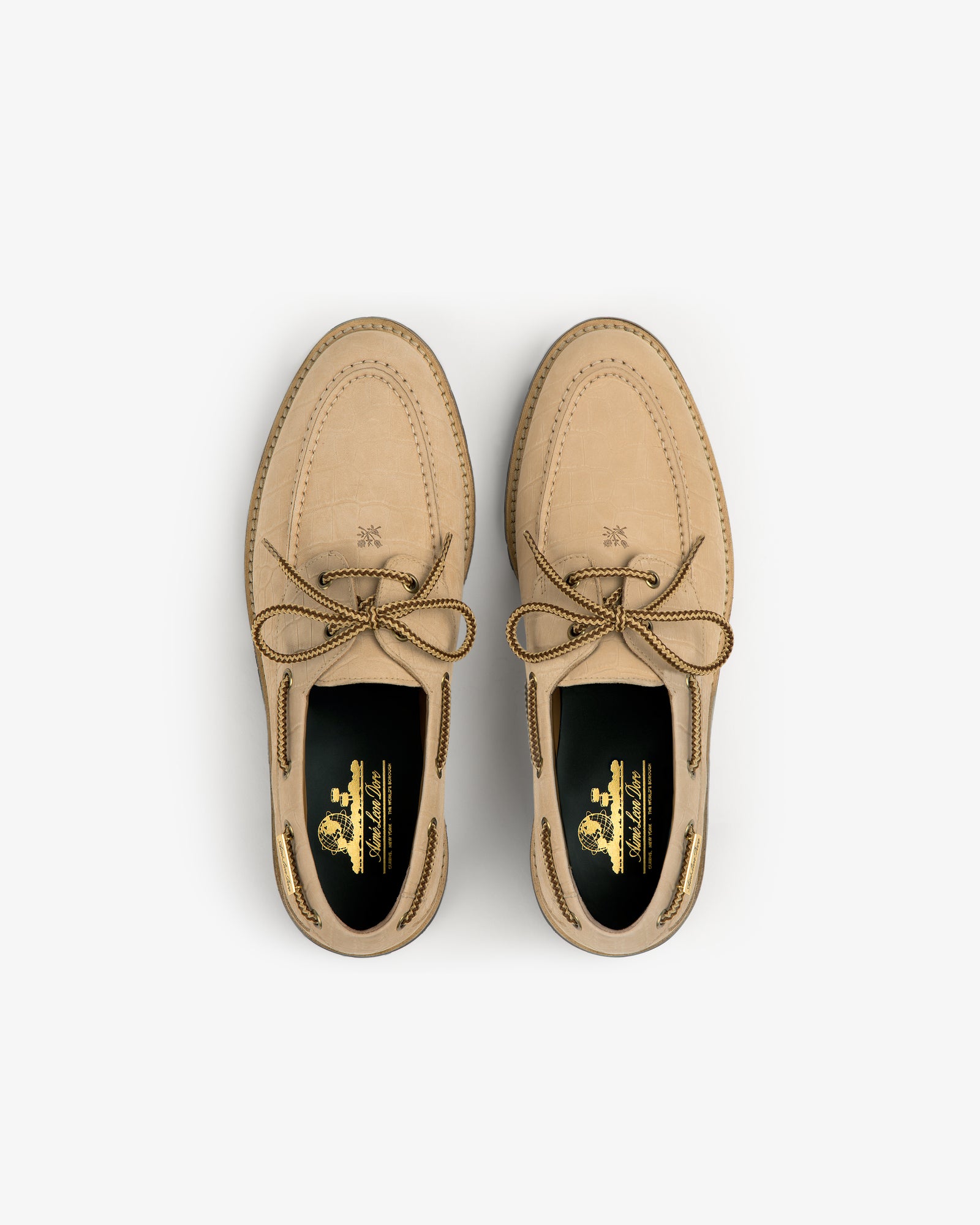 A pair of Pápia Boat Shoes in tan leather with brown laces, viewed from above on a white background.