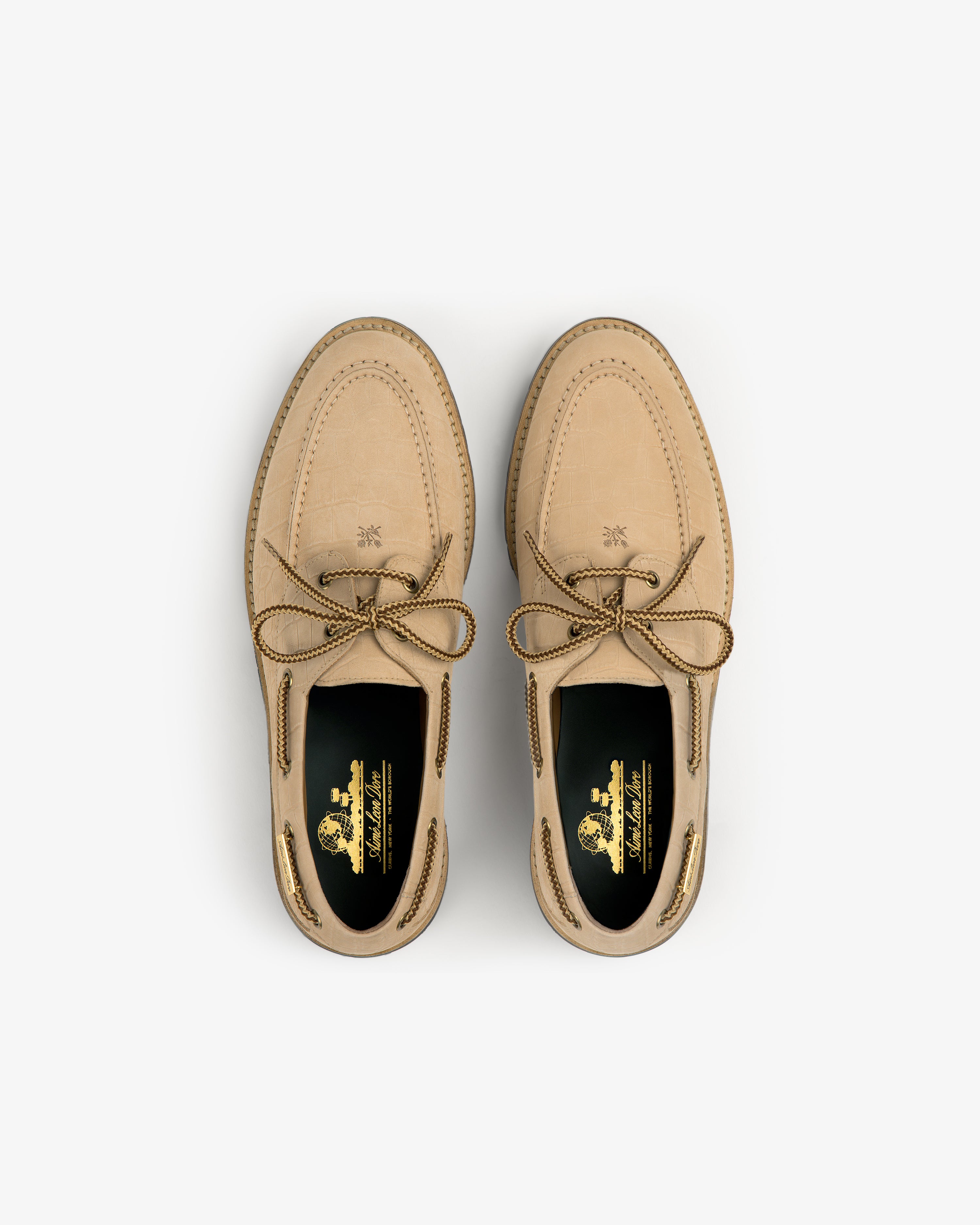A pair of Pápia Boat Shoes in tan leather with brown laces, viewed from above on a white background.