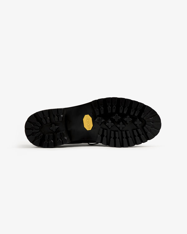 Leather Lug Sole Derby with deep-tread black sole and yellow Vibram logo, shown on a white background.