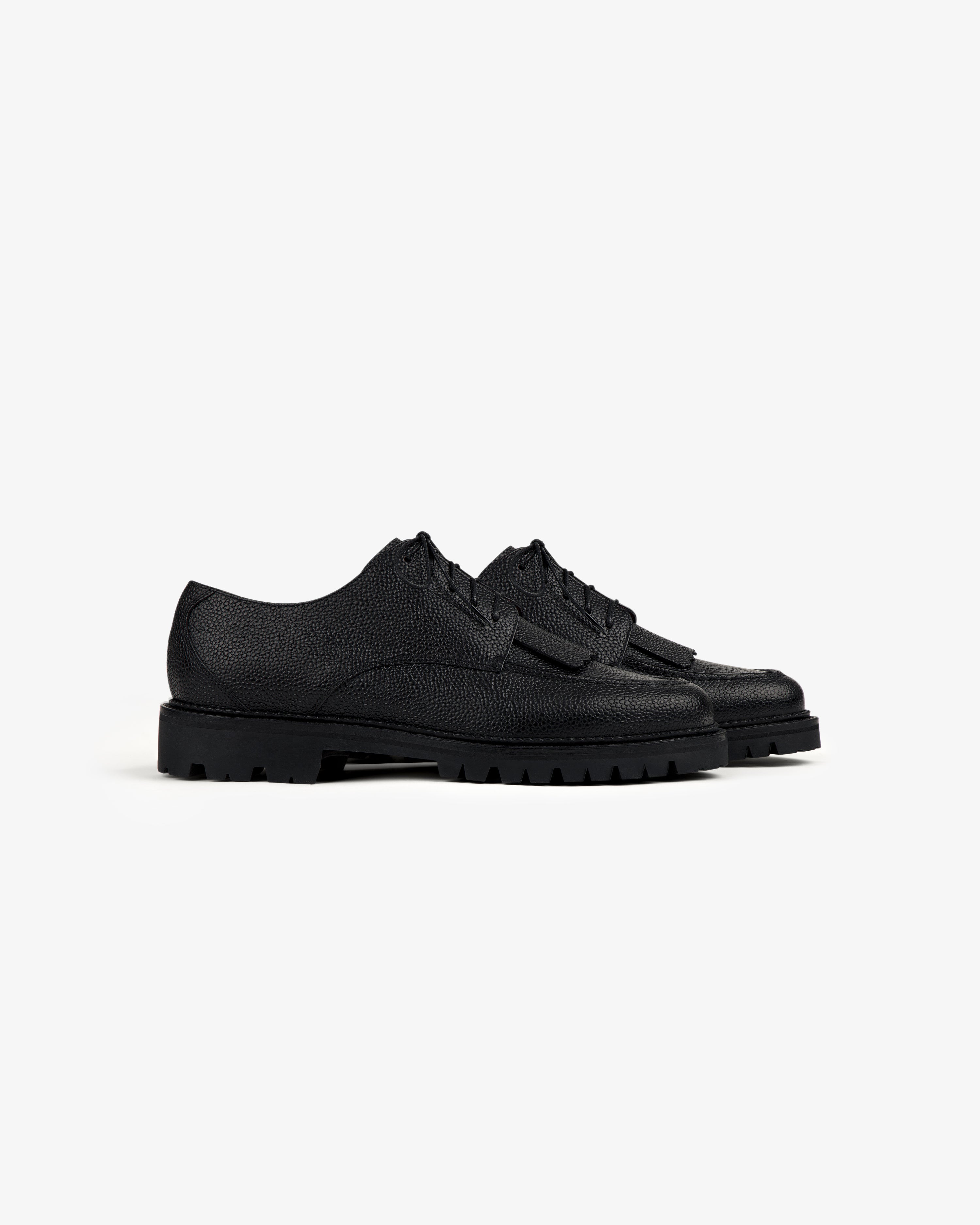 Leather Lug Sole Derby shoes in black leather with chunky rubber soles, shown on a plain white background.
