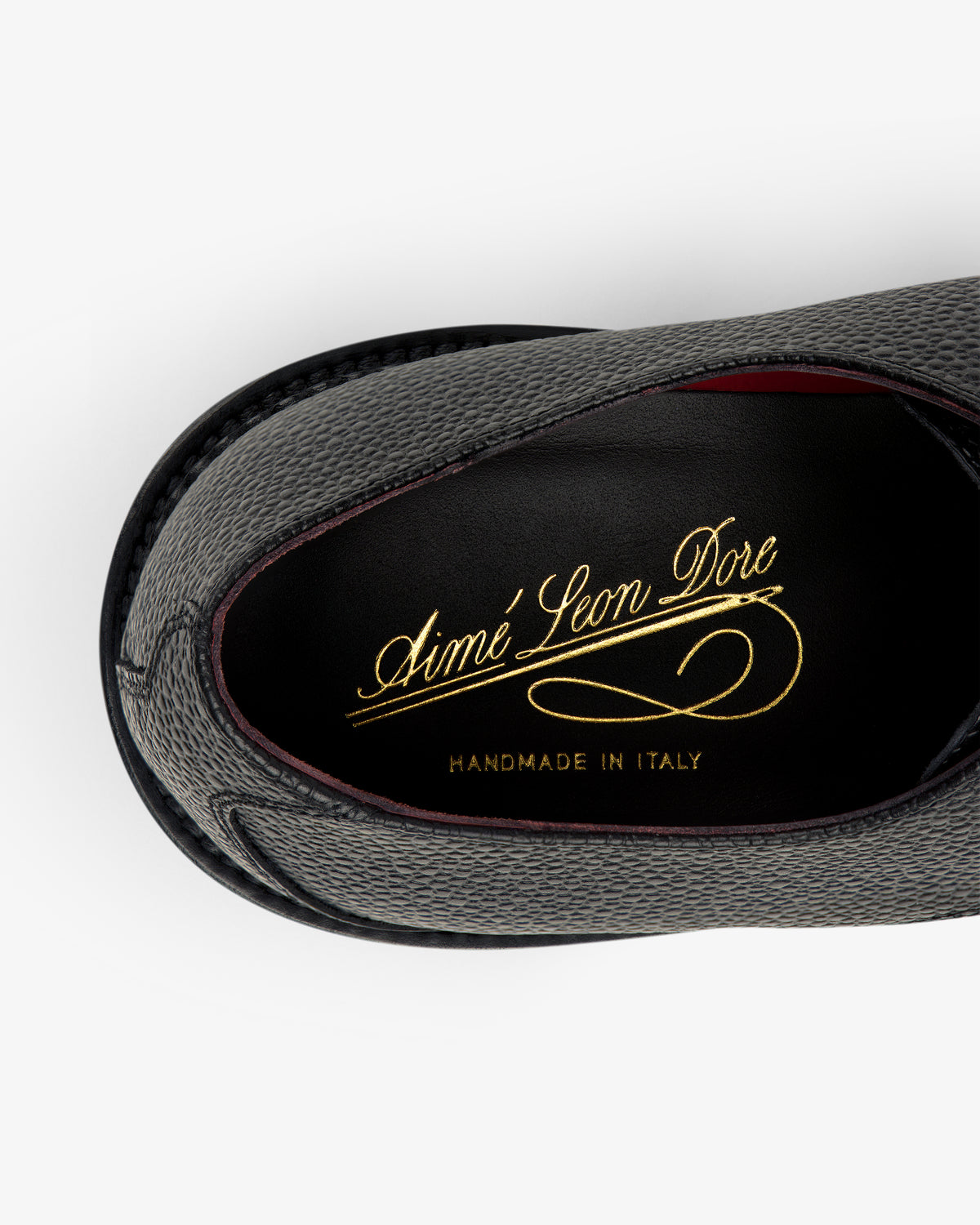Top view of the Leather Lug Sole Derby in gray with gold Aimé Leon Dore and Handmade in Italy text on black insole.