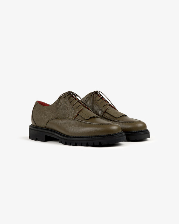 Leather Lug Sole Derby in olive green leather with textured finish and chunky black soles on a white background.