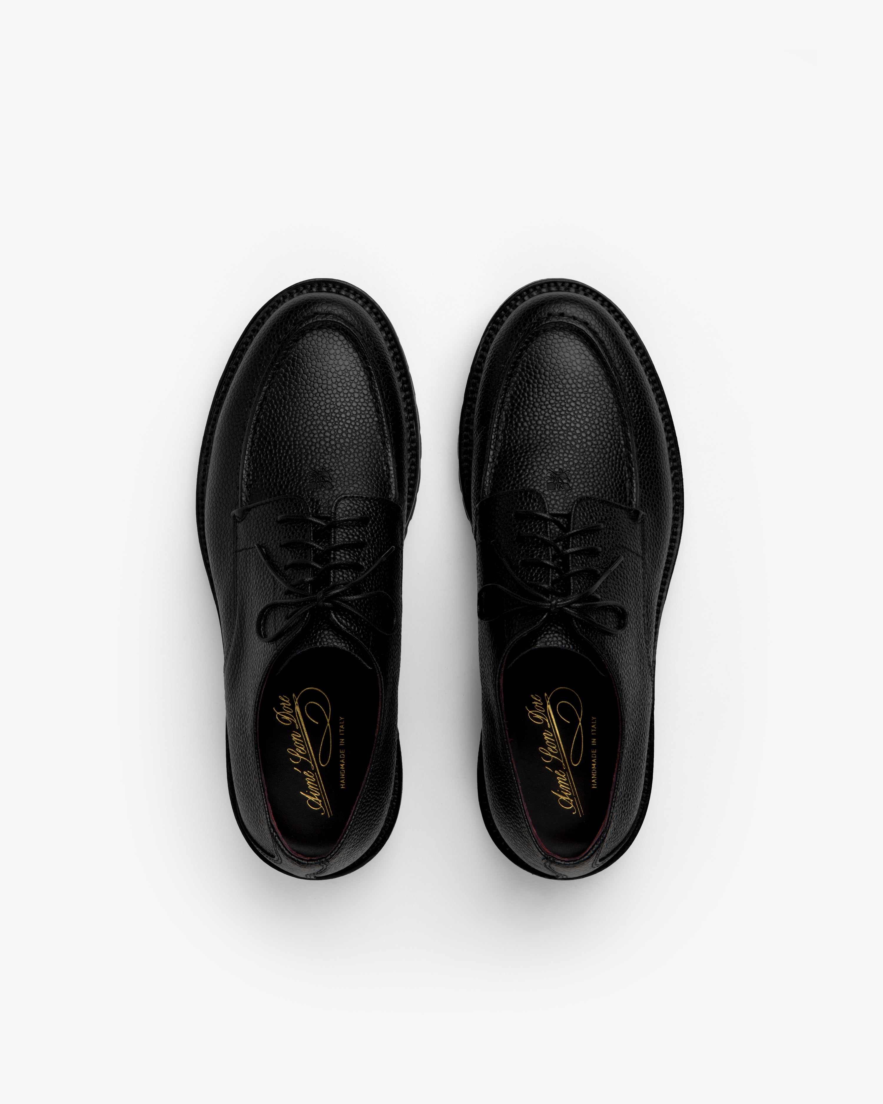 Top-down view of Leather Lug Sole Derby shoes in black textured leather with thick lug soles.