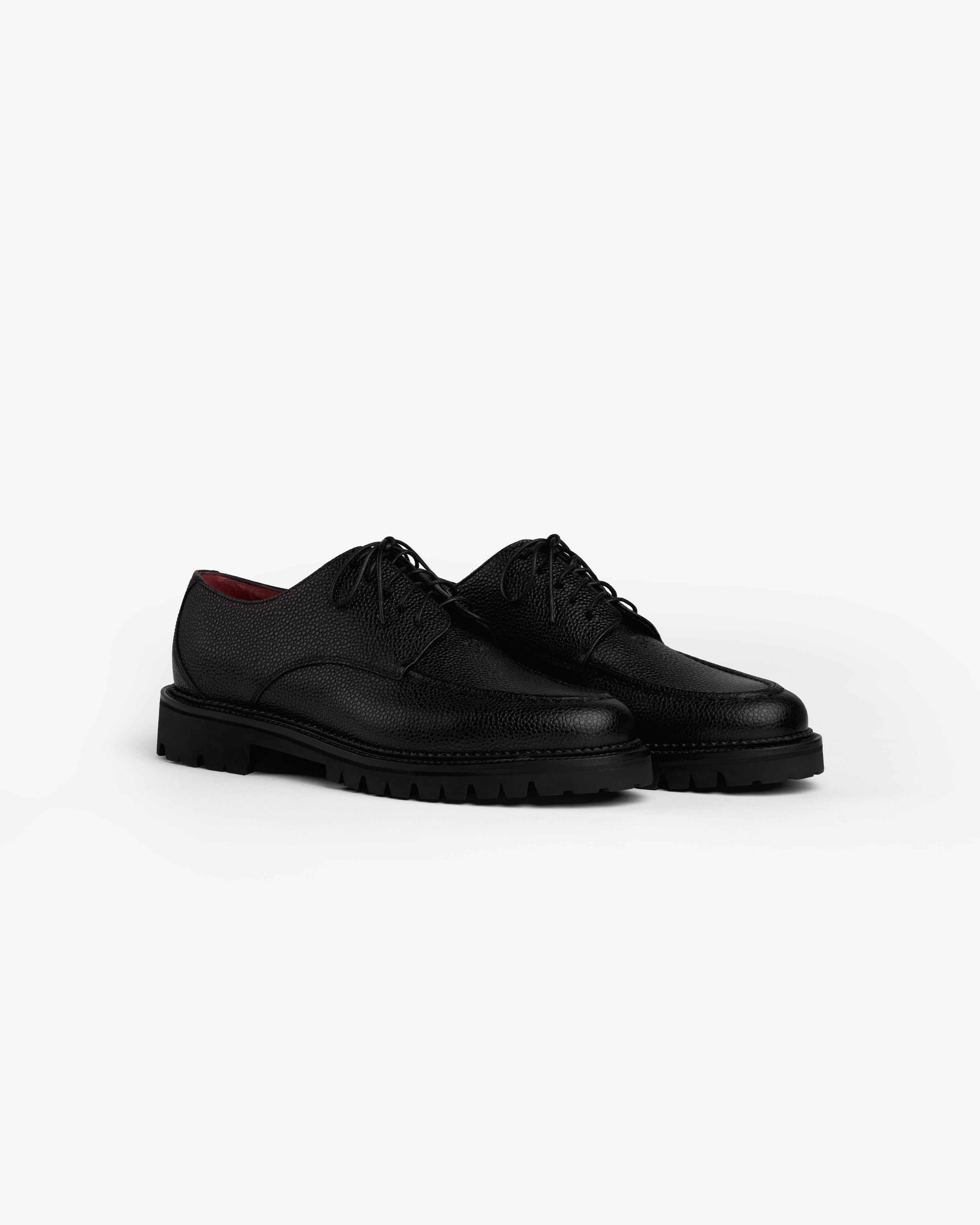 Leather Lug Sole Derby shoes in black leather with thick lug soles and lace-up closures.