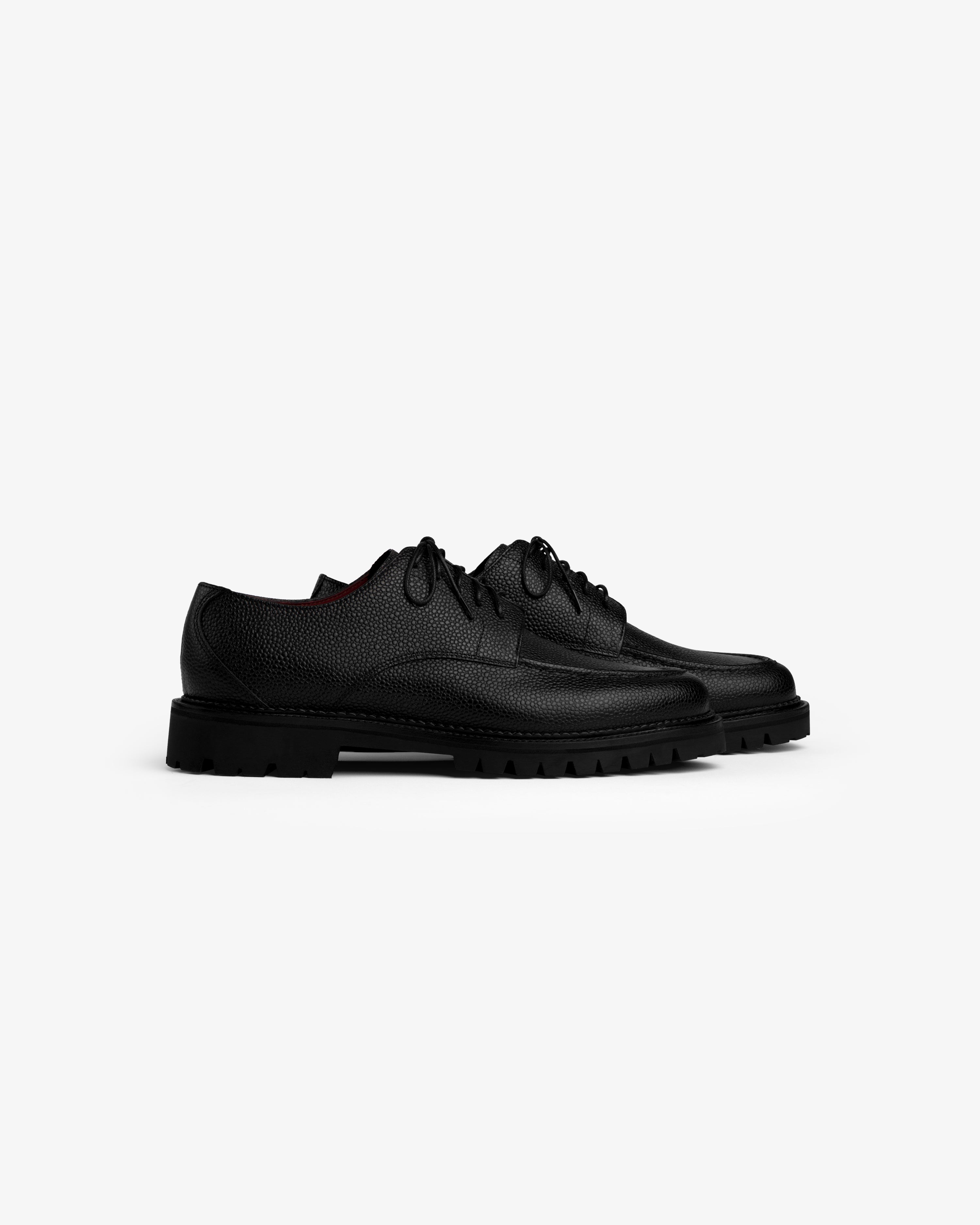 Leather Lug Sole Derby shoes in black with a lace-up design and thick lug soles.