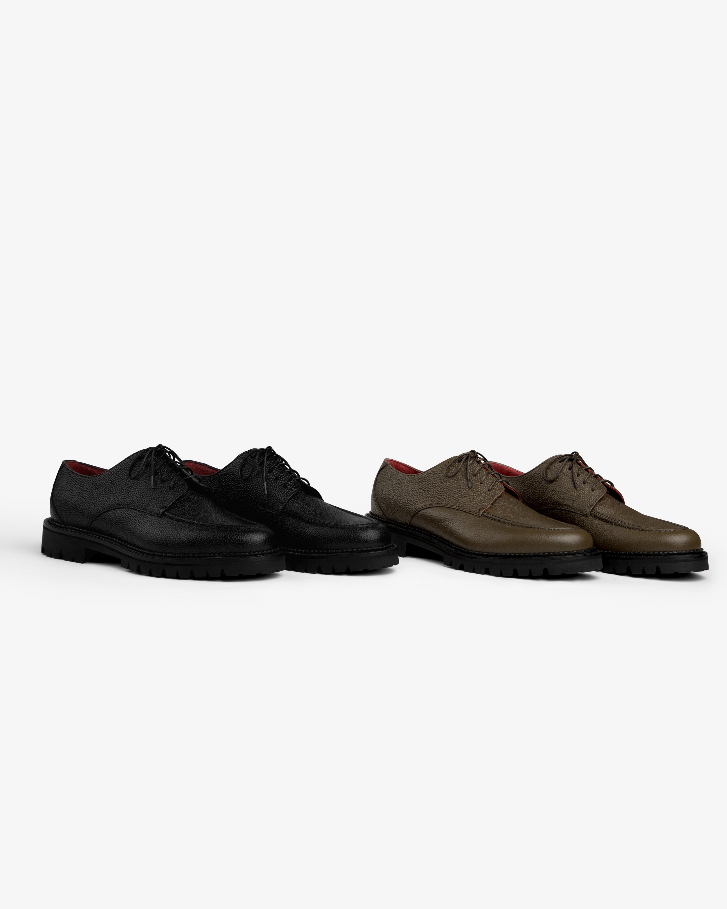 A pair of black and a pair of brown Leather Lug Sole Derby shoes with thick lug soles.
