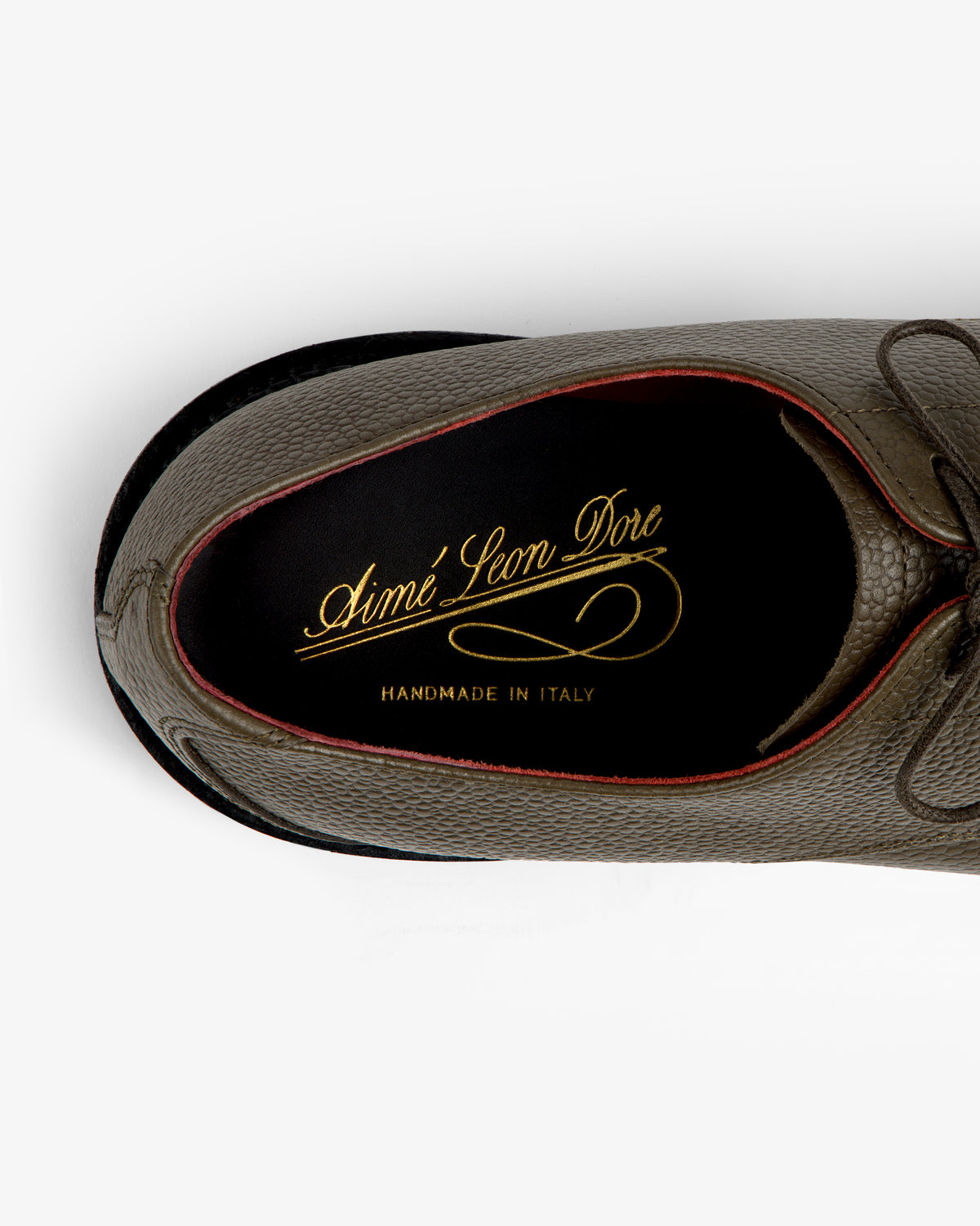 Top-down view of a textured olive Leather Lug Sole Derby interior with a gold brand logo on the insole.