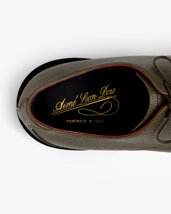 Top-down view of a textured olive Leather Lug Sole Derby interior with a gold brand logo on the insole.