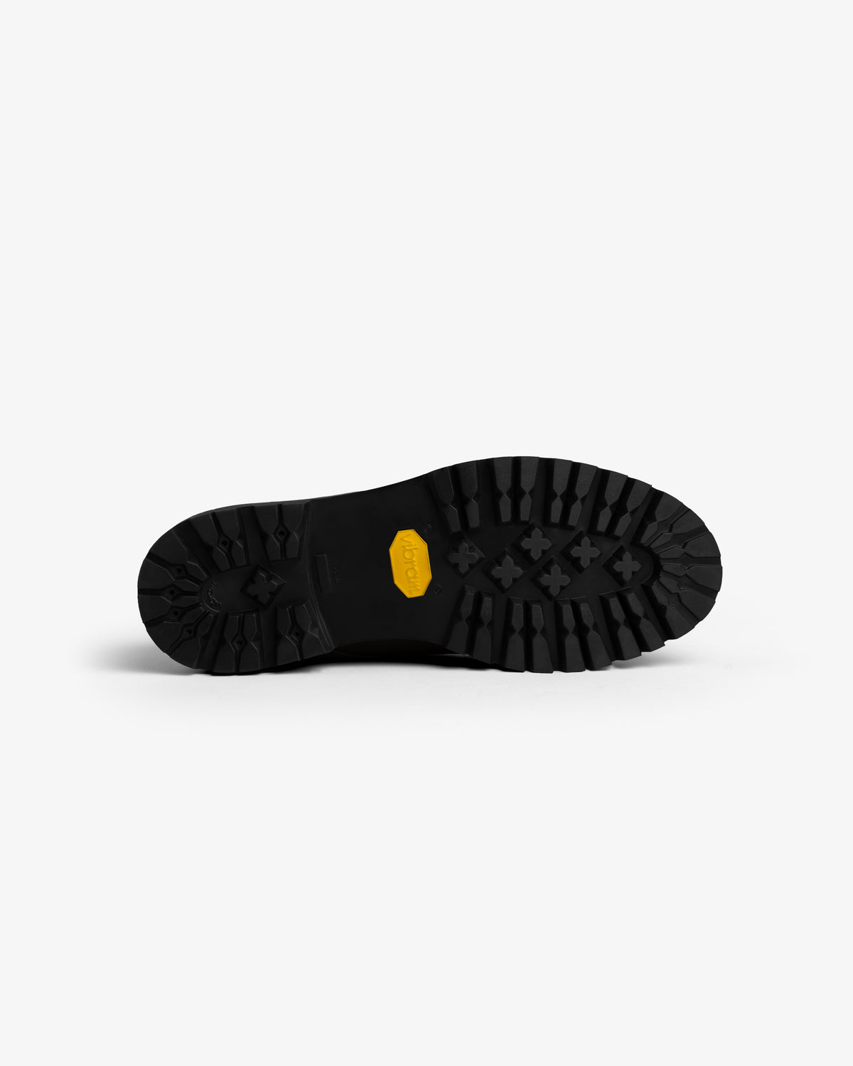 The Leather Lug Sole Derby features a black sole with deep lugs and a central yellow logo patch.