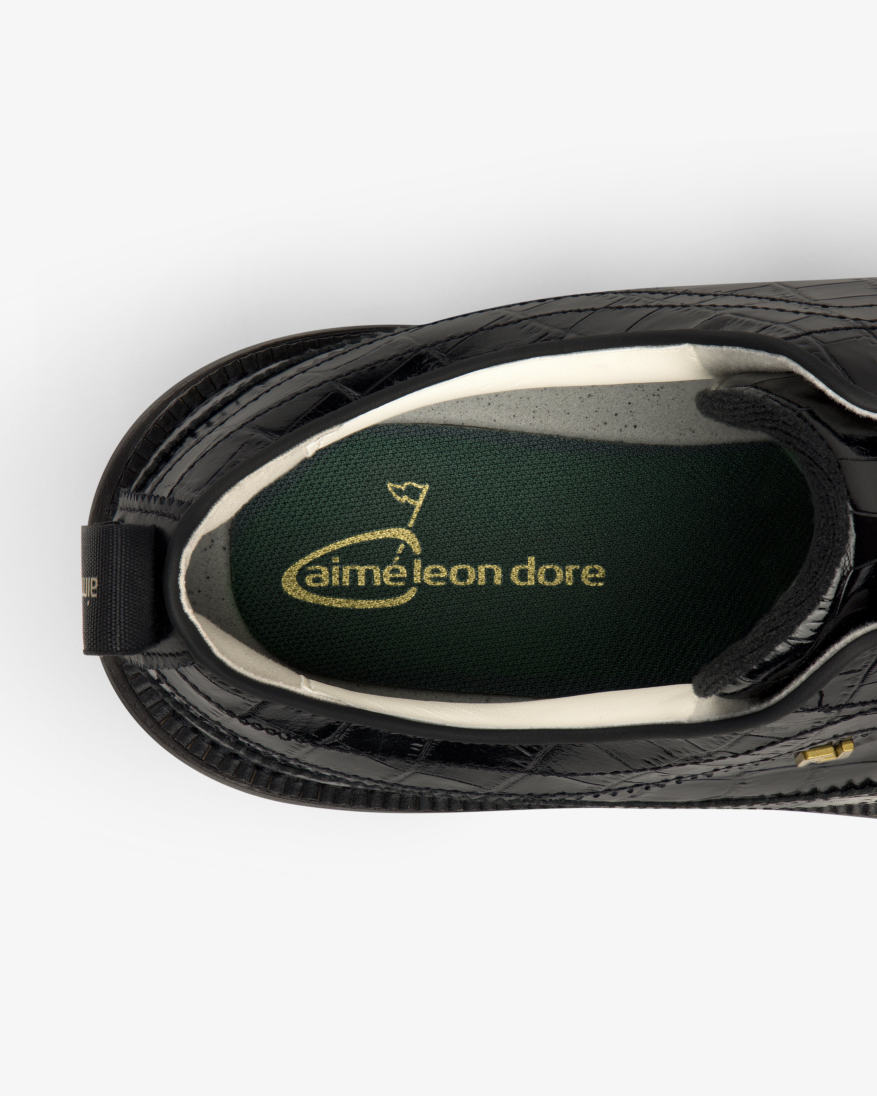 Top view of the ALD / Footjoy Croc-Embossed Premiere Series Marquis with a green insole and gold aimé leon dore text.
