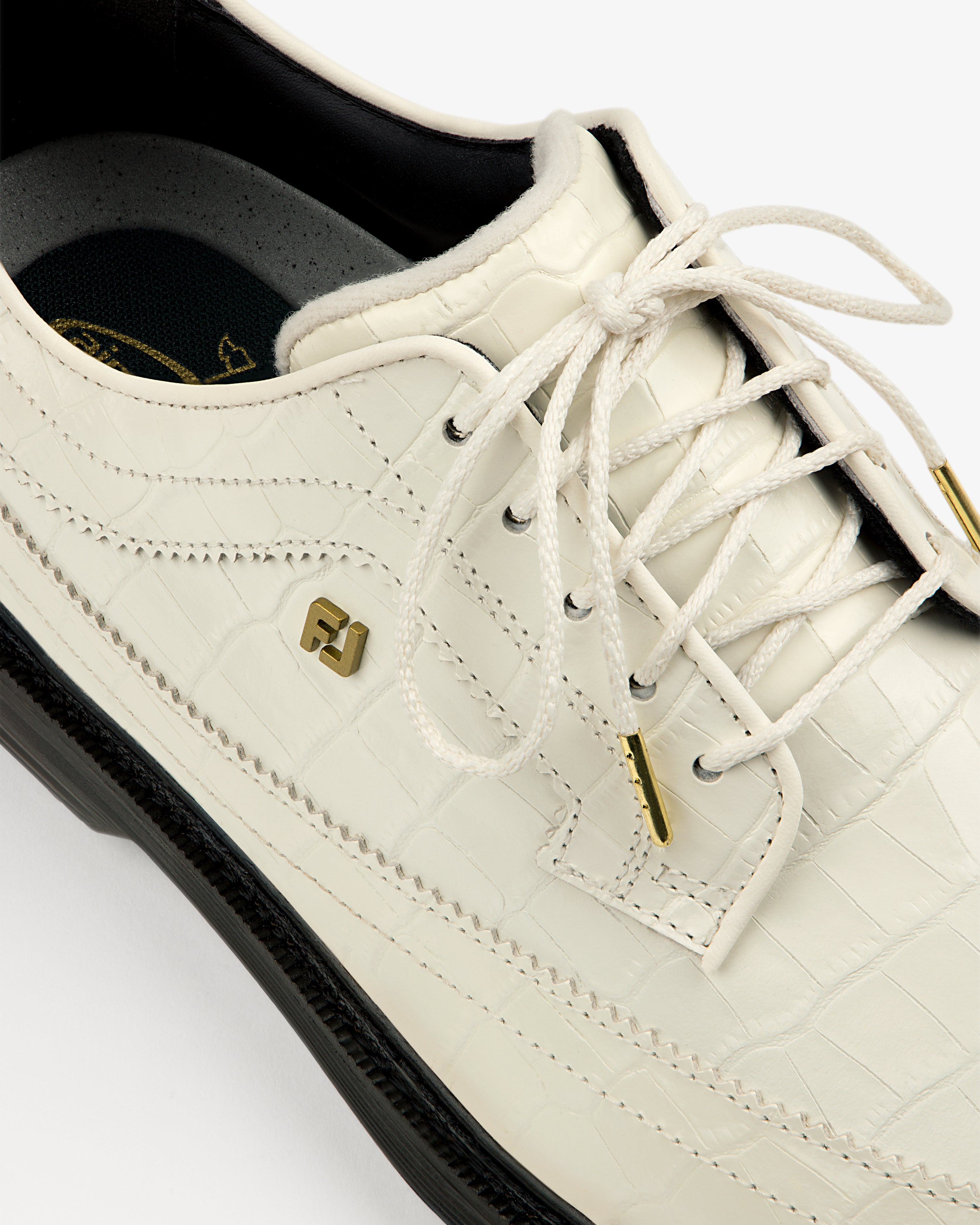 Close-up of ALD / Footjoy Croc-Embossed Premiere Series Marquis shoe with gold accents and black sole, top view.