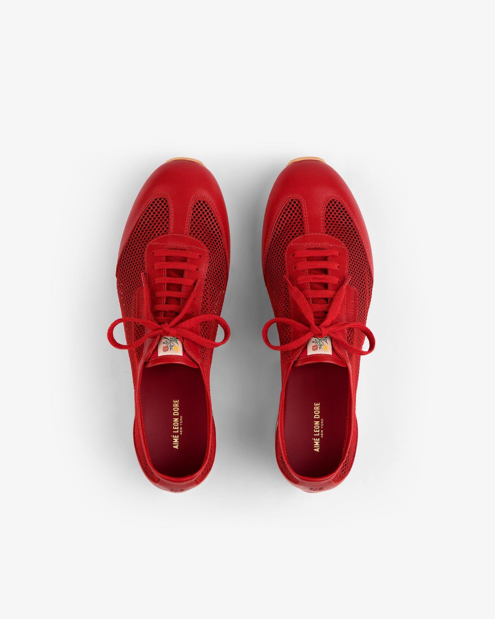 Low Profile Mesh Trainer in bright red, lace-up style, viewed from above on a white background.
