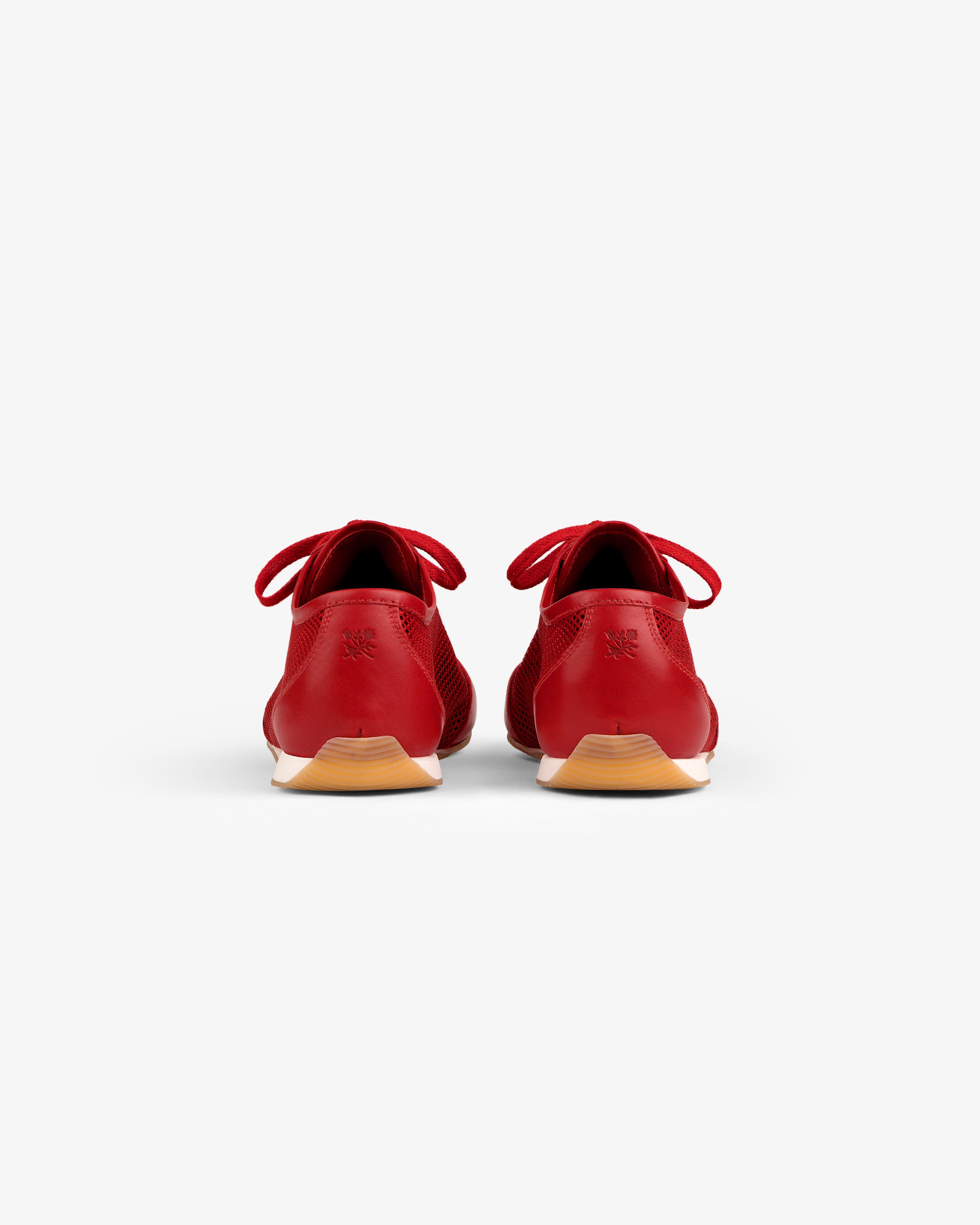 Low Profile Mesh Trainer in red, viewed from the back showing heels and light brown outsoles on a white background.