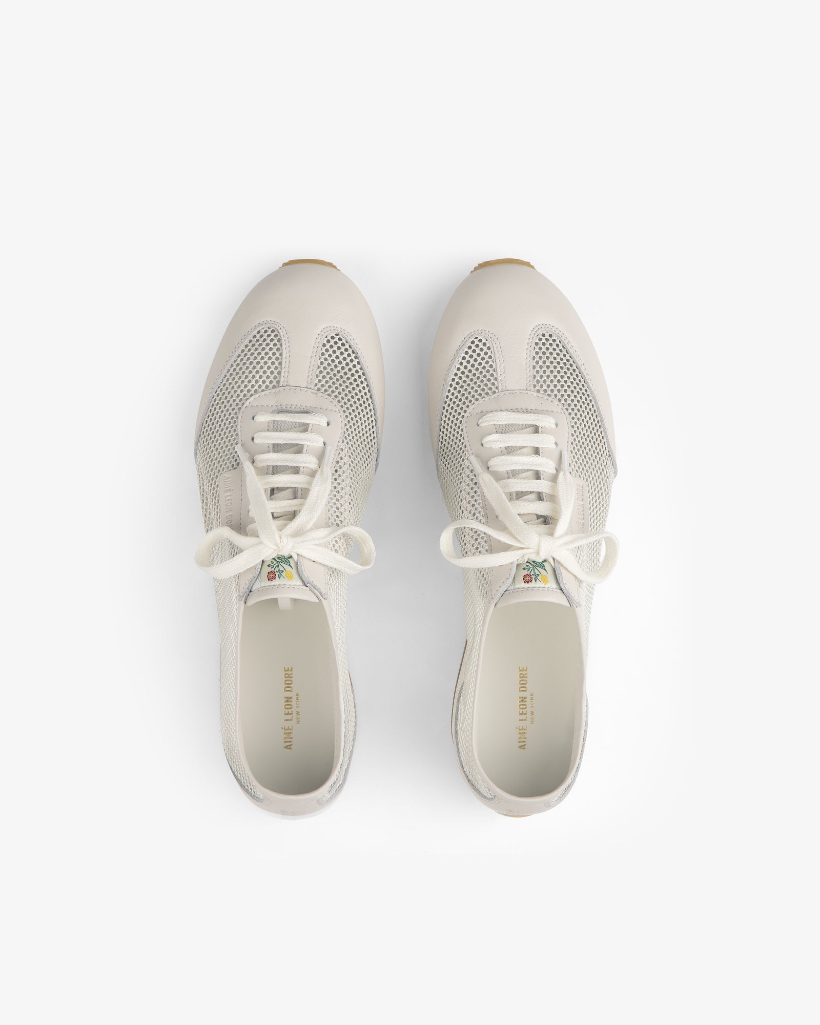 The Low Profile Mesh Trainer sneakers with white laces, seen from above on a plain white background.