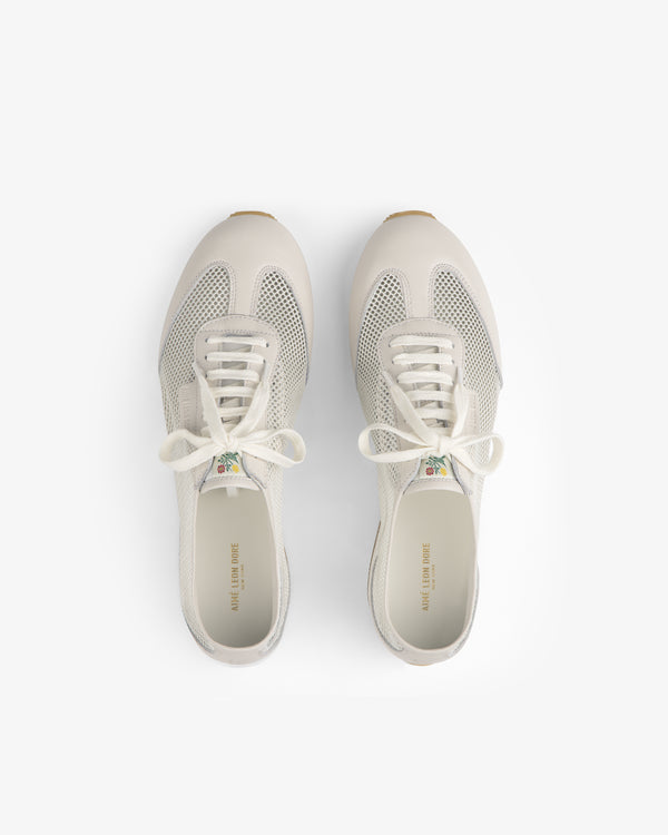 The Low Profile Mesh Trainer sneakers with white laces, seen from above on a plain white background.