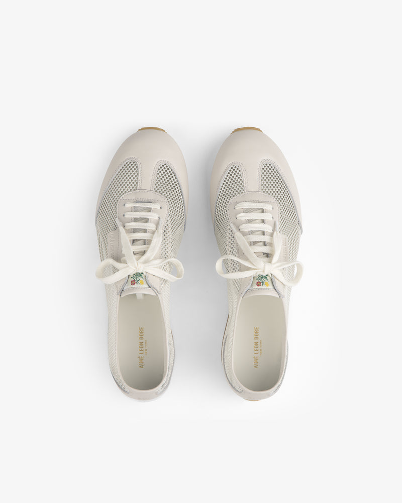 The Low Profile Mesh Trainer sneakers with white laces, seen from above on a plain white background.