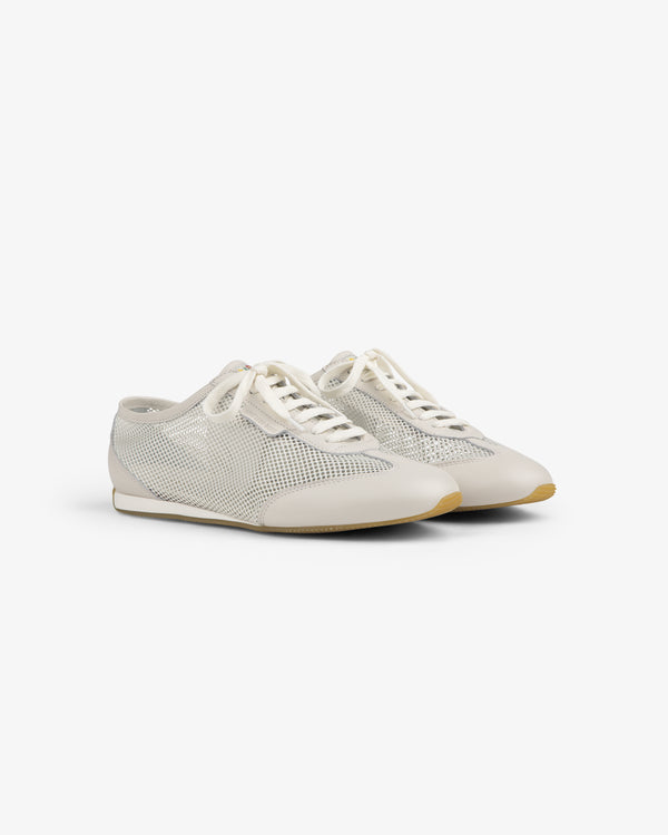 Low Profile Mesh Trainer: white mesh sneakers with lace-up fronts and beige soles, shown on a plain white background.