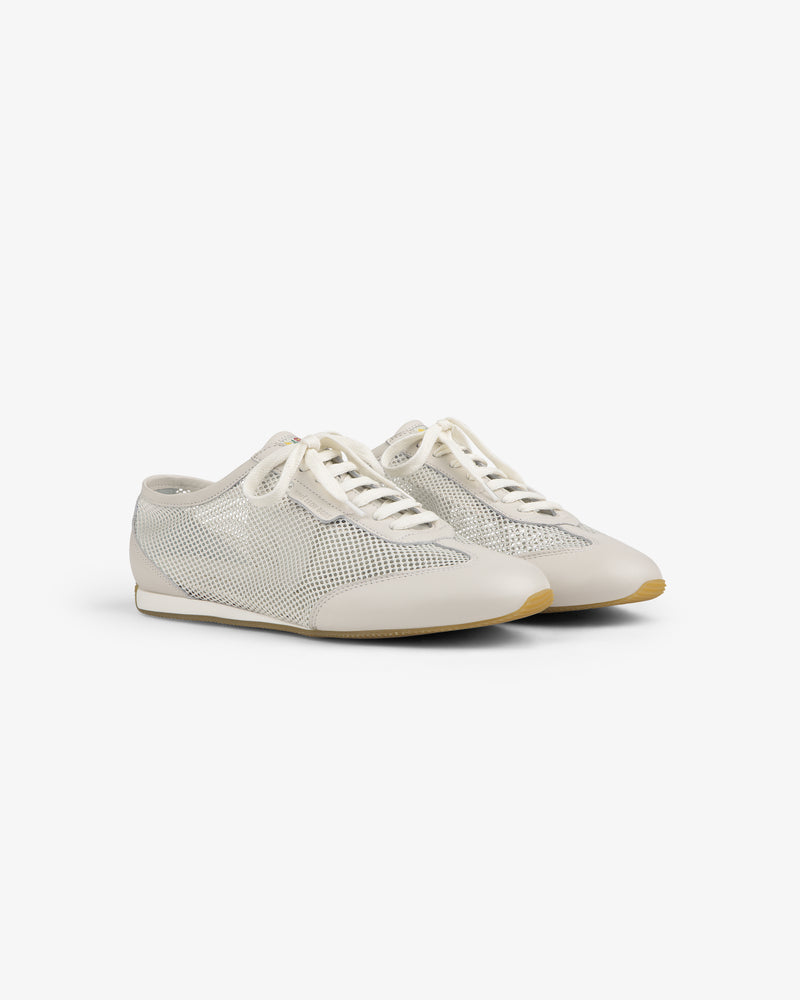 Low Profile Mesh Trainer: white mesh sneakers with lace-up fronts and beige soles, shown on a plain white background.