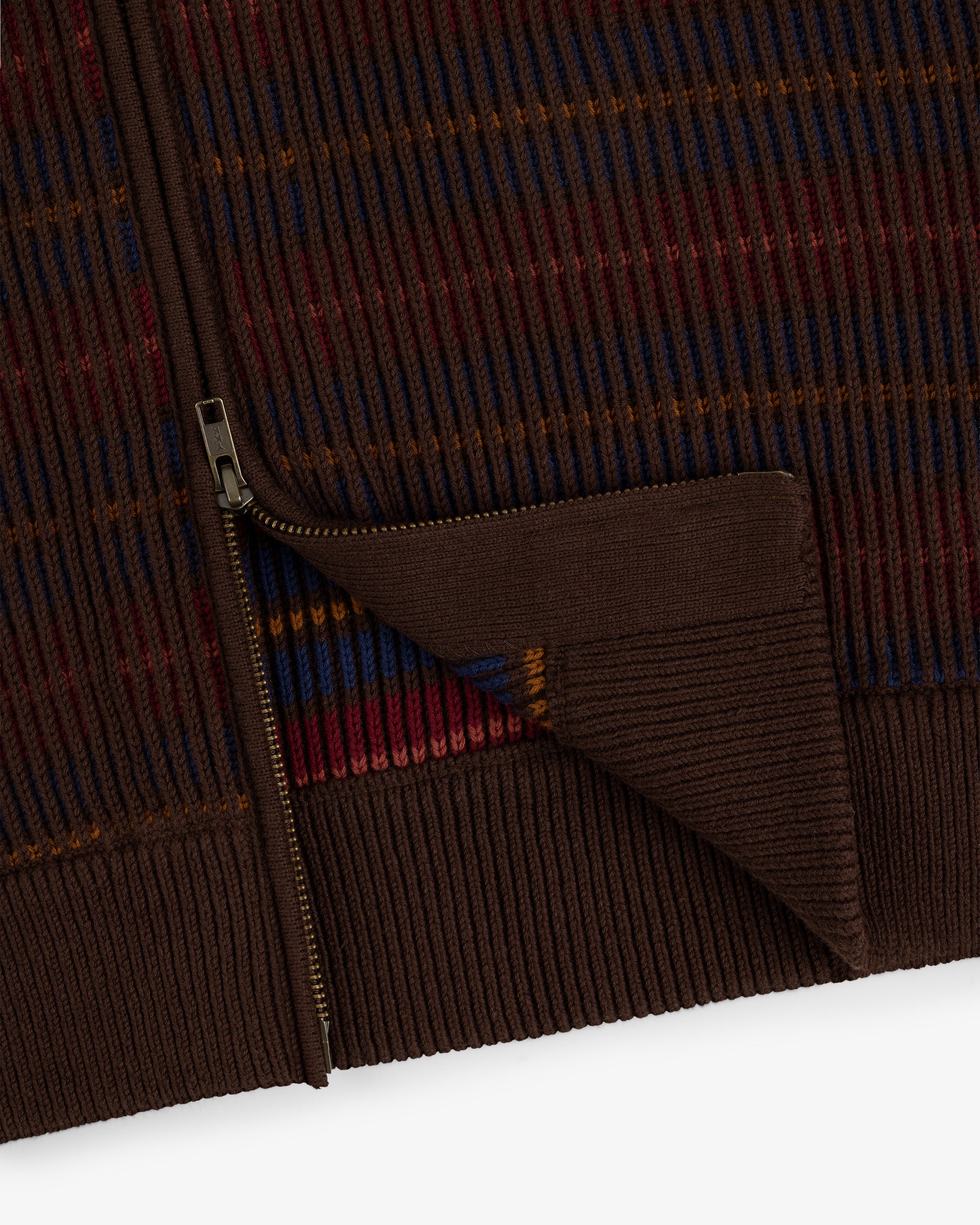 Close-up of the Multi Color Knit Track Sweater: brown ribbed knit with a gold zipper and red, blue, orange stripes.