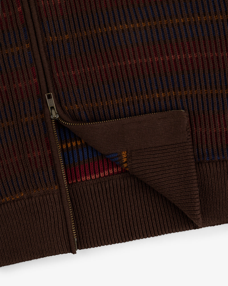 Close-up of the Multi Color Knit Track Sweater: brown ribbed knit with a gold zipper and red, blue, orange stripes.