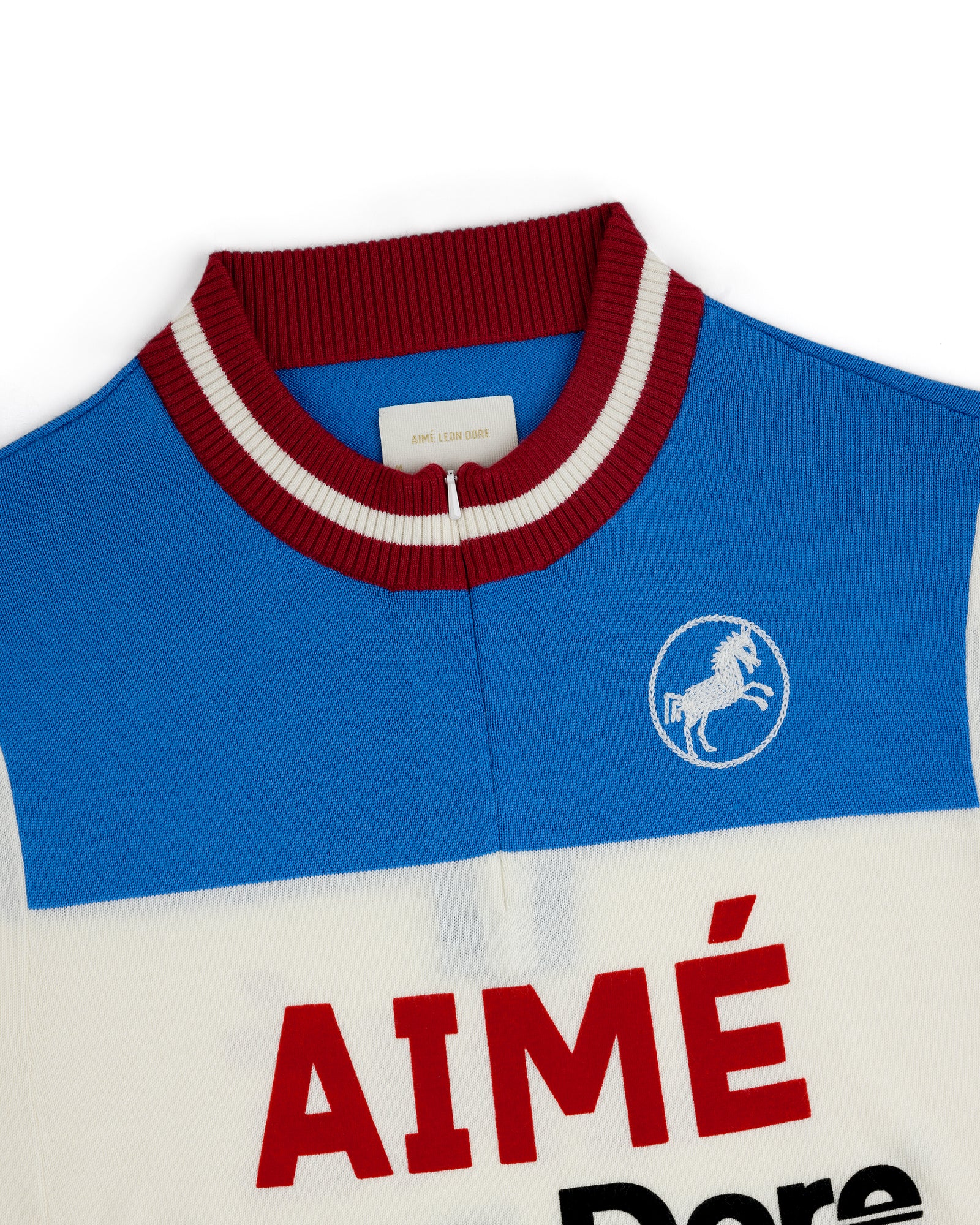 Blue and white Merino Wool Cycling Jersey with red collar, Aimé Dore text, and horse logo.