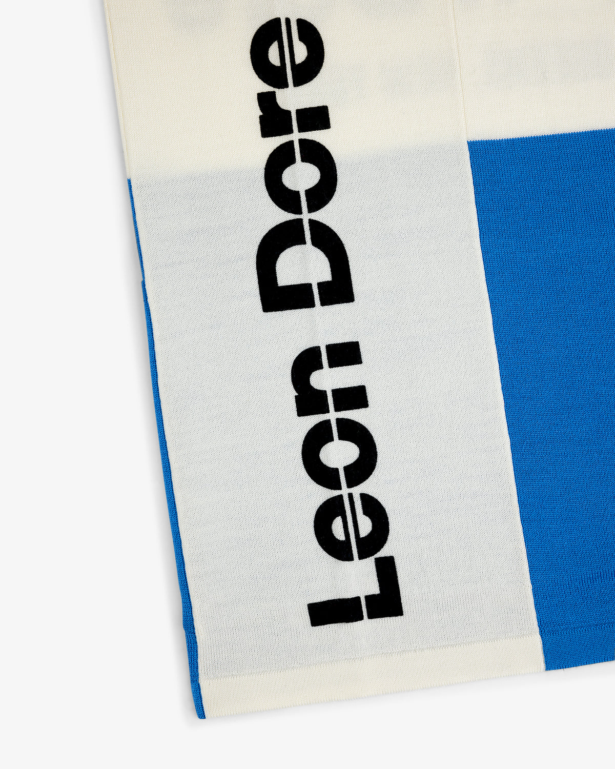 White and blue Merino Wool Cycling Jersey with bold black Leon Dore text vertically.