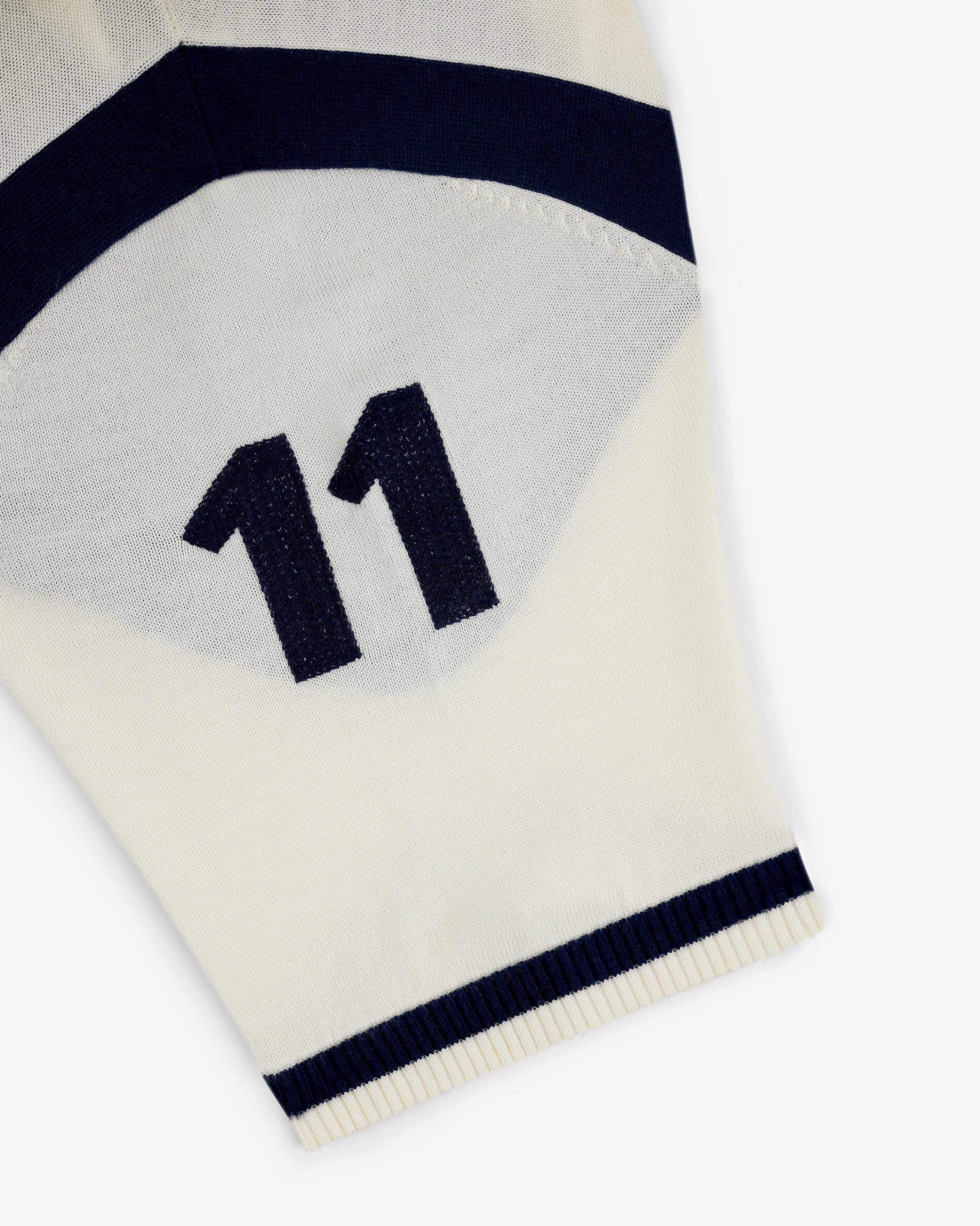 A Merino Wool Cycling Jersey in white with navy stripes and the number 11 printed in navy.