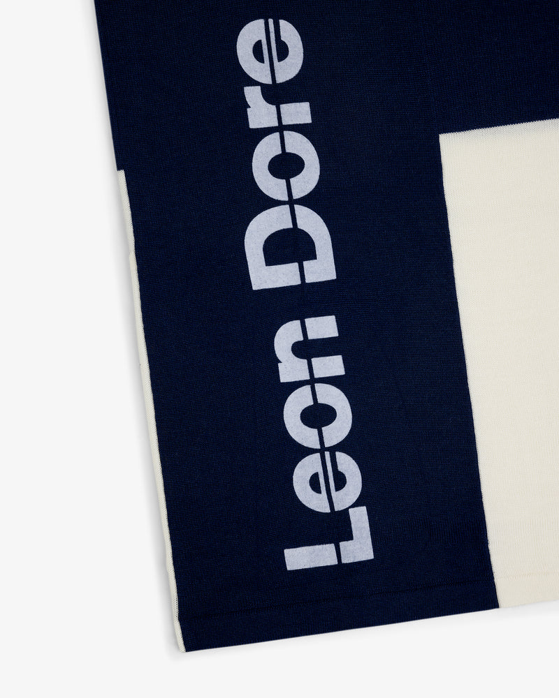 Navy Merino Wool Cycling Jersey with large white Leon Dore print beside a cream-colored section.