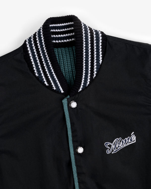 Reversible Knit Bomber Jacket with striped ribbed collar and Aimé embroidered on the chest in white script.