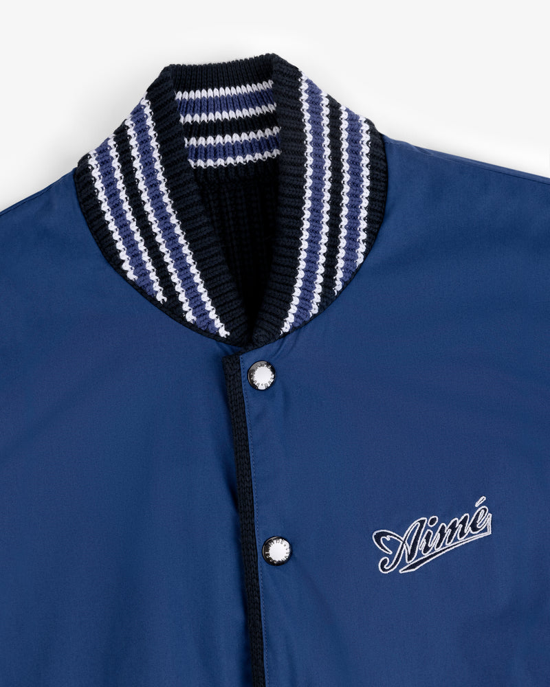 Reversible Knit Bomber Jacket with striped ribbed collar, snap buttons, and cursive Aimé logo on the chest.