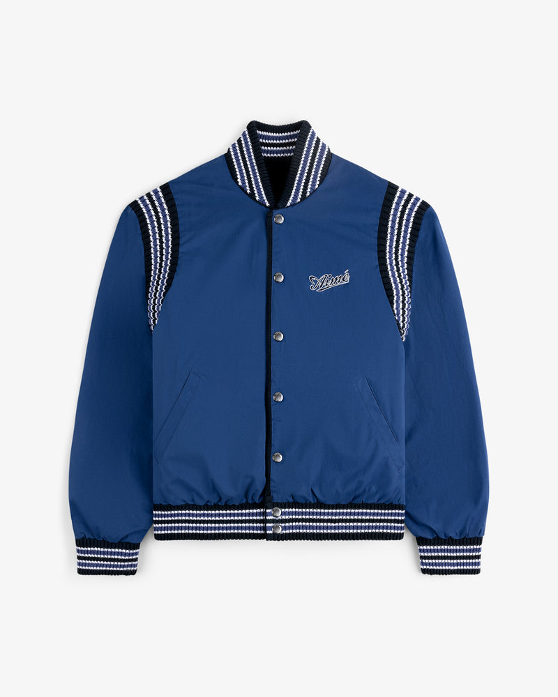 Reversible Knit Bomber Jacket in blue with black and white striped trim and "Saint" embroidered on the chest.