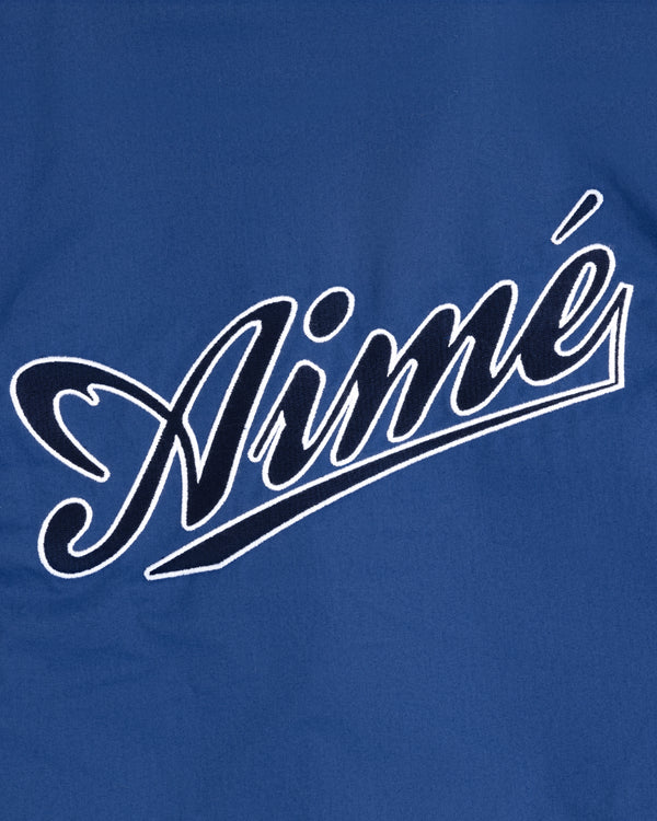 Blue Reversible Knit Bomber Jacket featuring "Aimé" in white cursive script across the center.