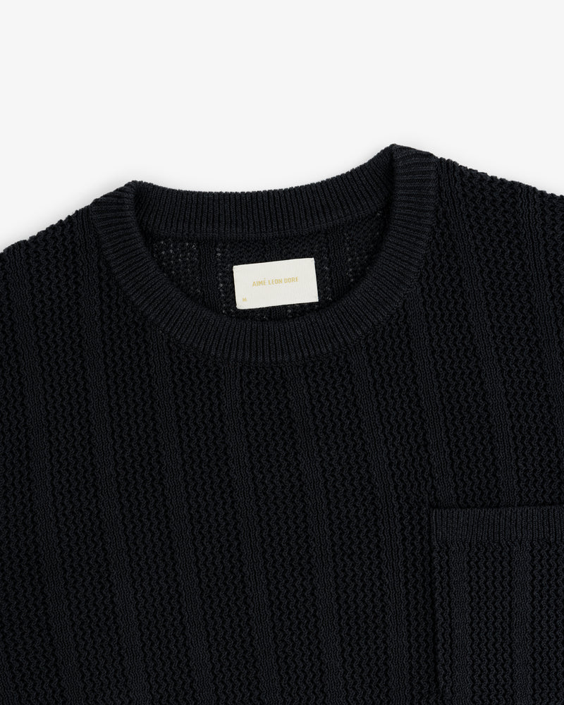 Racking Stitch Crewneck Sweater in black, textured knit with a chest pocket, shown on a white background.