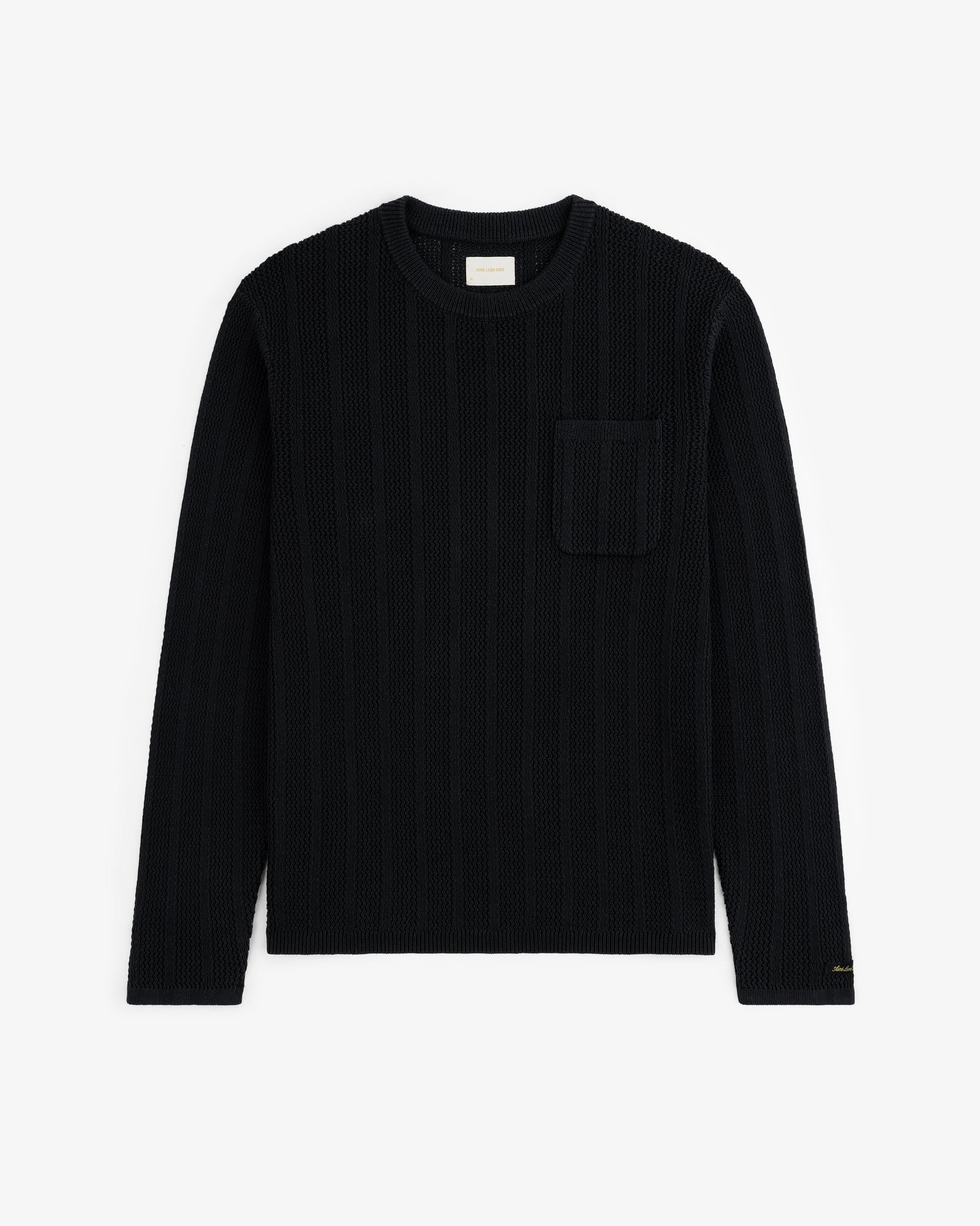 The Racking Stitch Crewneck Sweater in black with long sleeves and chest pocket, shown flat on a white background.