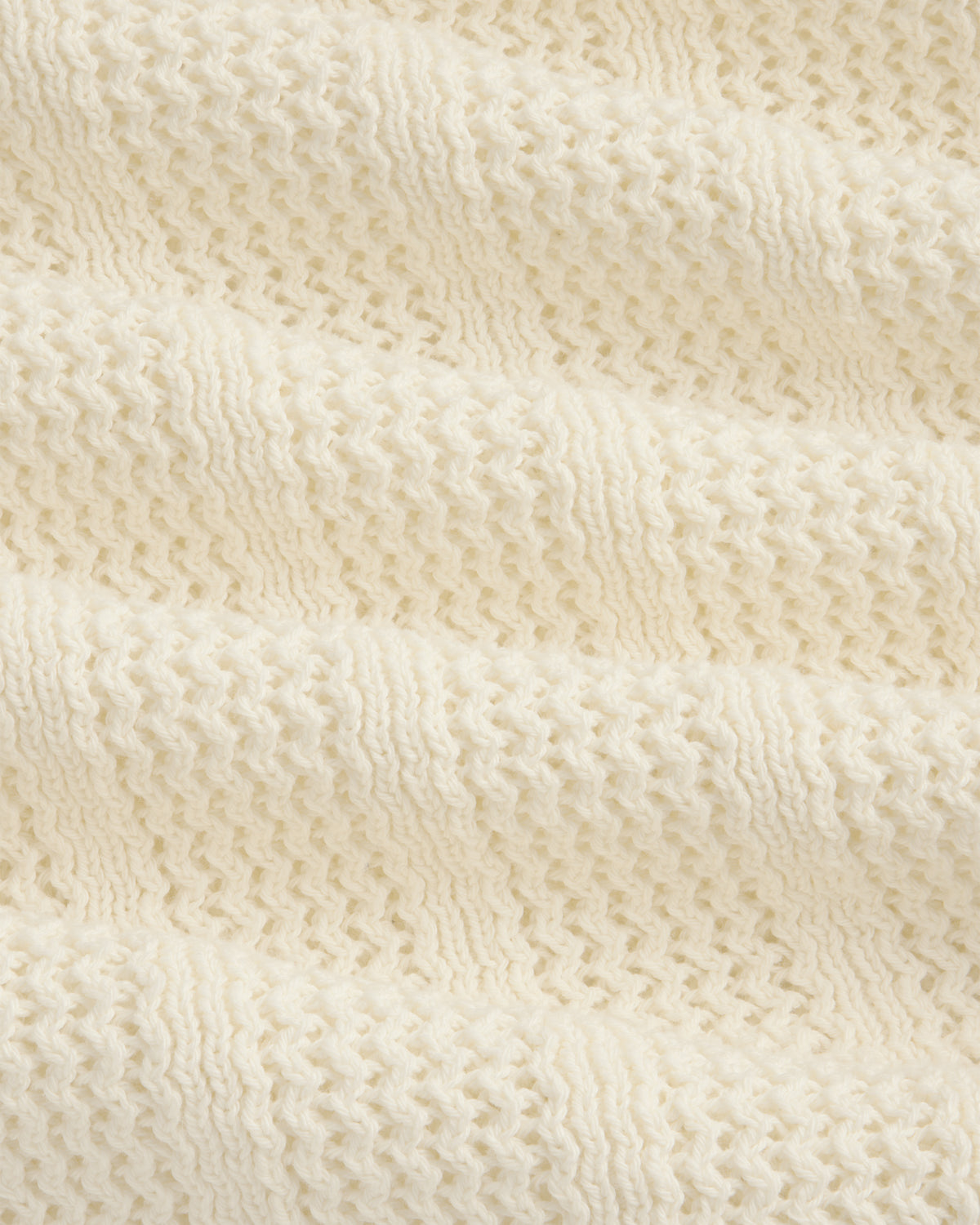 Close-up of the Racking Stitch Crewneck Sweater in cream, showing its textured, wavy knit pattern.