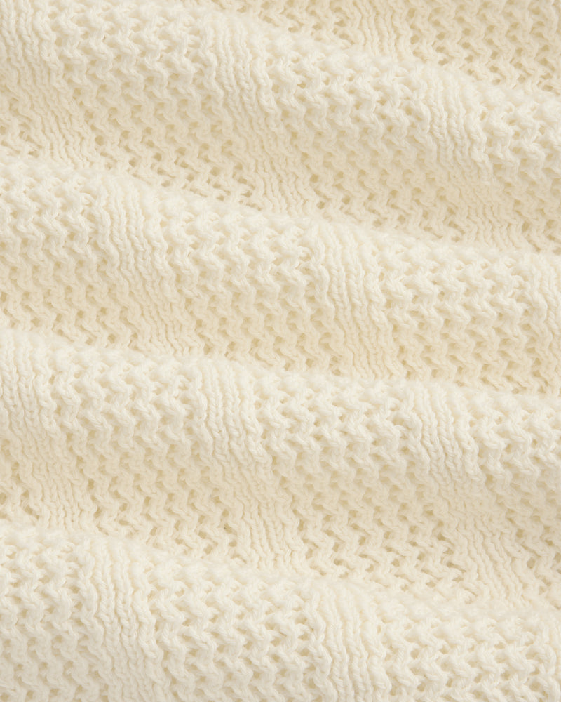 Close-up of the Racking Stitch Crewneck Sweater in cream, showing its textured, wavy knit pattern.