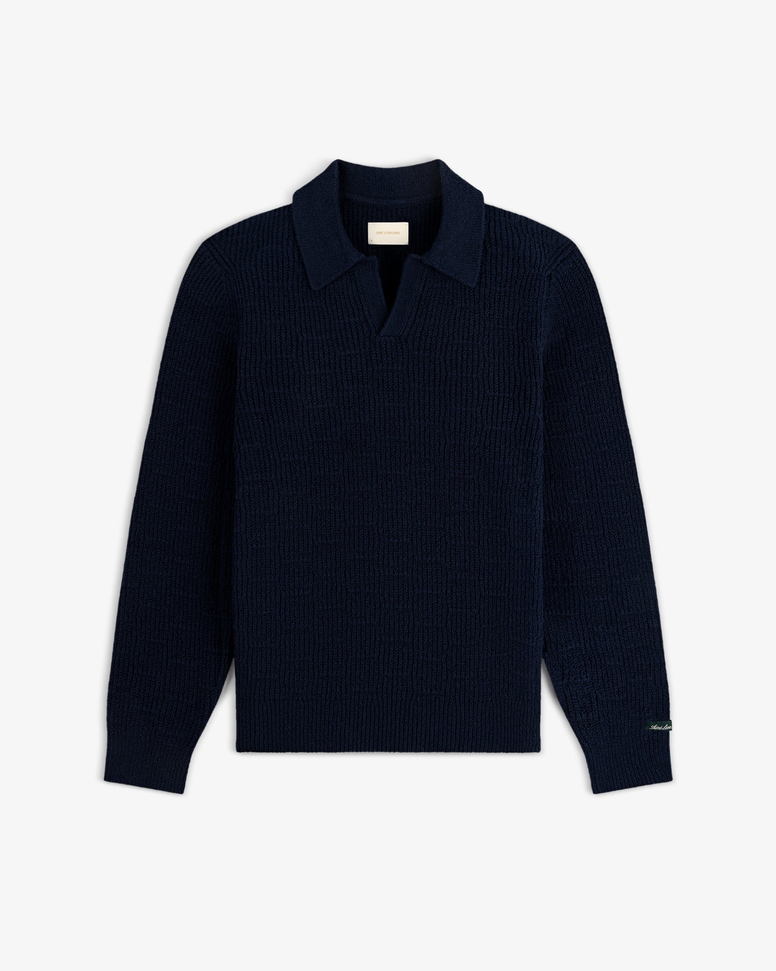 Long-Sleeve Boucle Polo in navy blue with collar and open placket, laid flat on a white background.