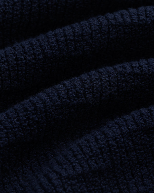 Close-up of the Long-Sleeve Boucle Polo in dark blue, highlighting its soft, ribbed knit texture and raised lines.