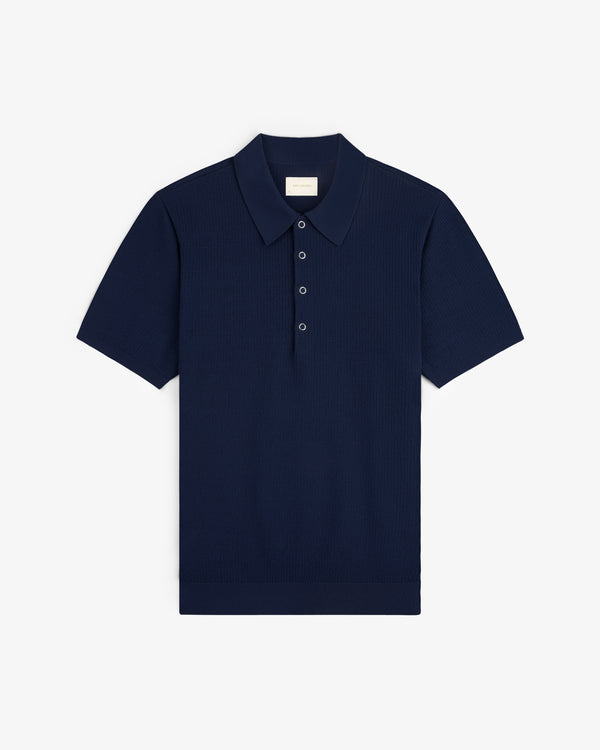 Navy blue Knit Polo with short sleeves, classic collar, and three buttons, shown flat on a white background.