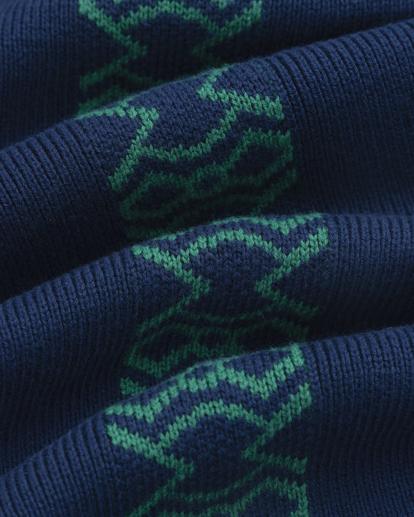 Close-up of Knit Sport Pullover in dark blue with a green geometric pattern.