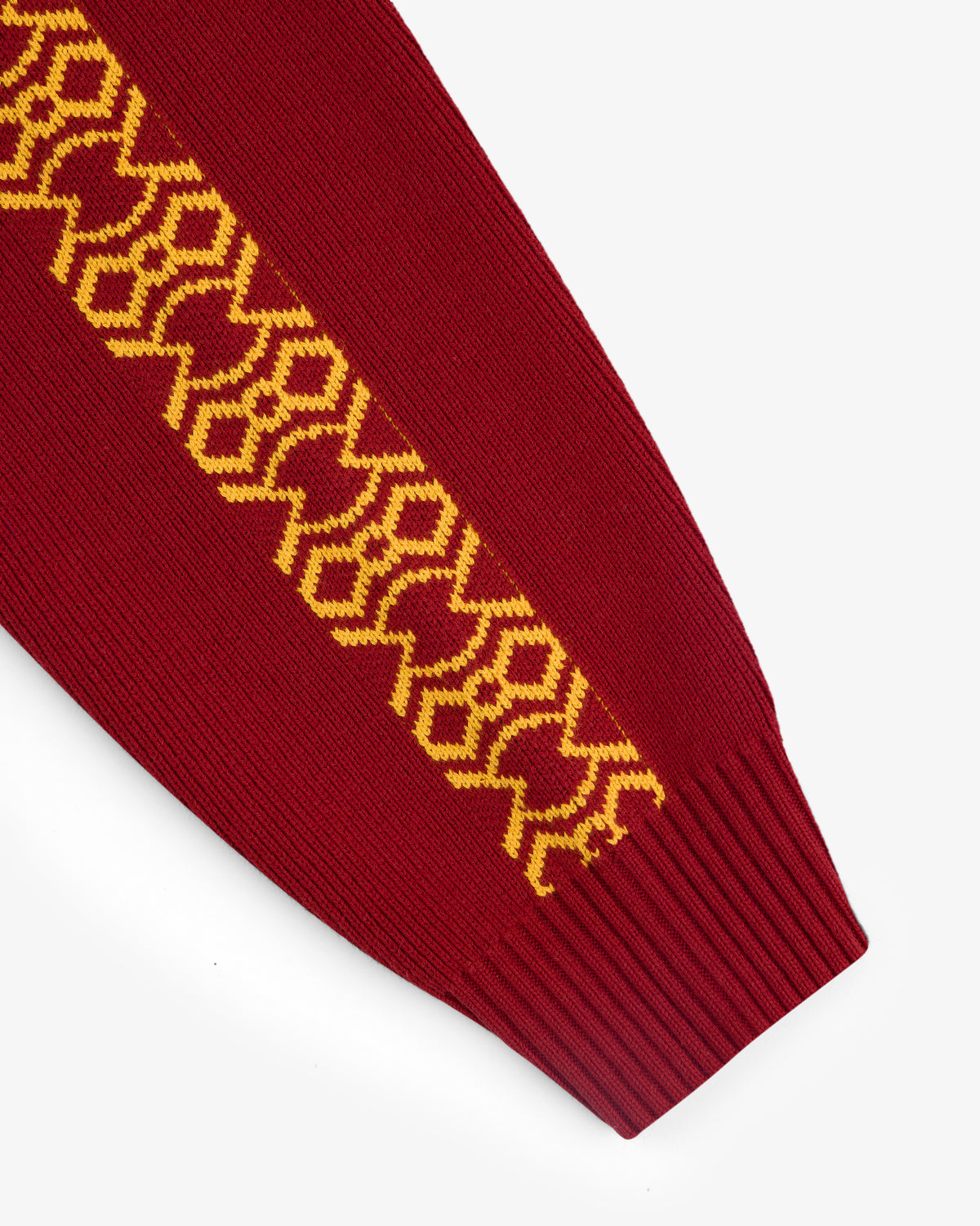 Knit Sport Pullover in red with yellow geometric sleeve pattern, displayed on a white background.