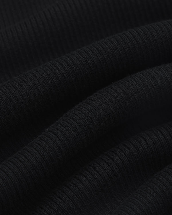 Close-up of Sport Knit Henley in black, showing ribbed fabric with horizontal textured lines and soft folds.