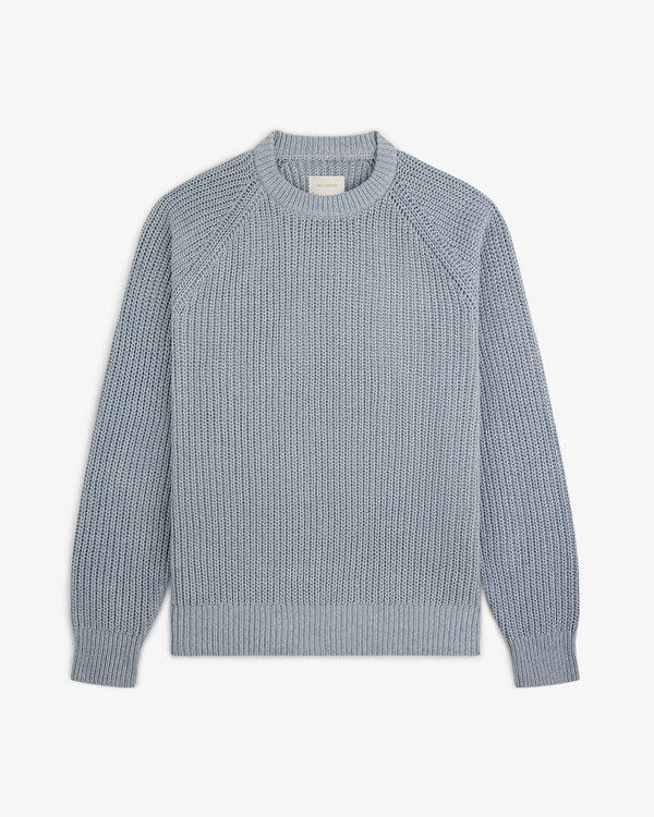 Knit Denim Crewneck Sweater in light blue with long sleeves and ribbed cuffs, hem, and collar on a white background.