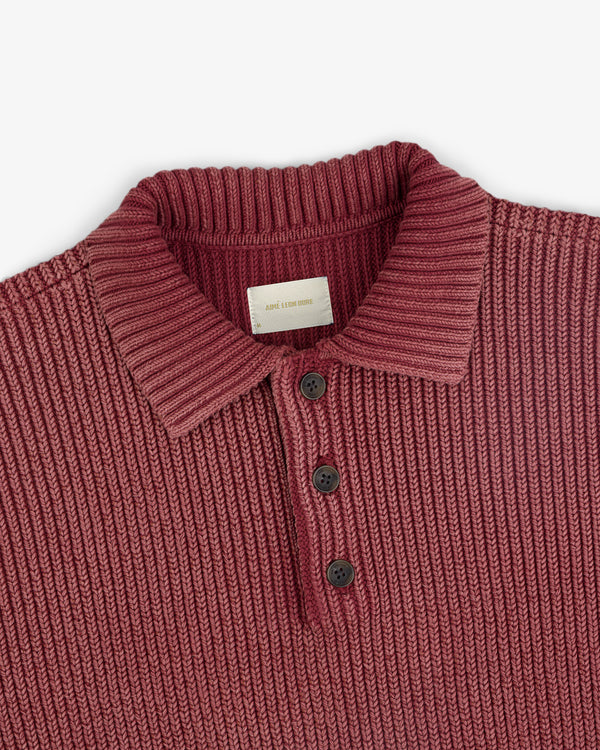 The Stone Washed Knit Polo is a ribbed maroon shirt with a collar and three black buttons, shown flat on white.